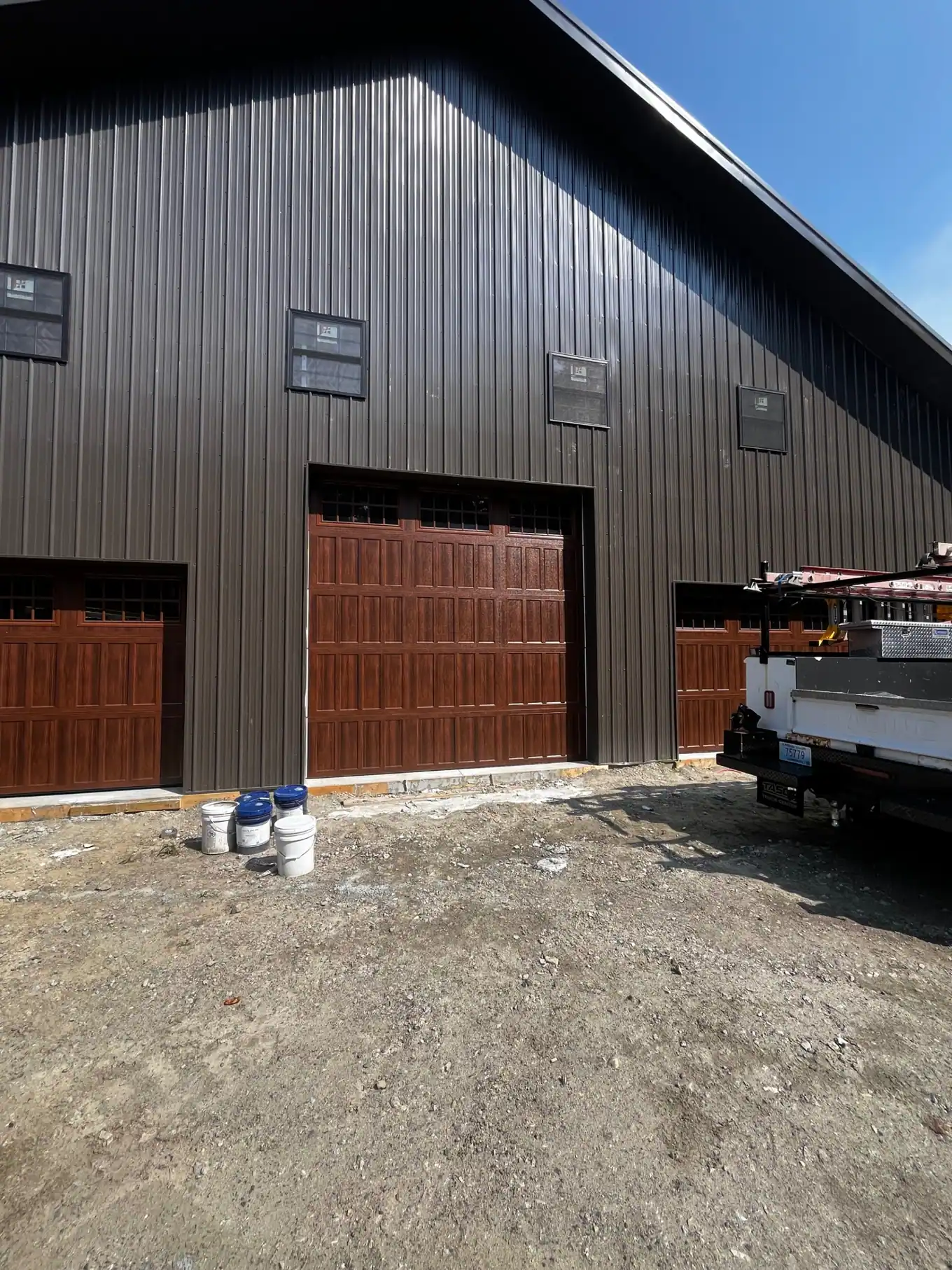 Wood-look commercial garage doors on a metal building