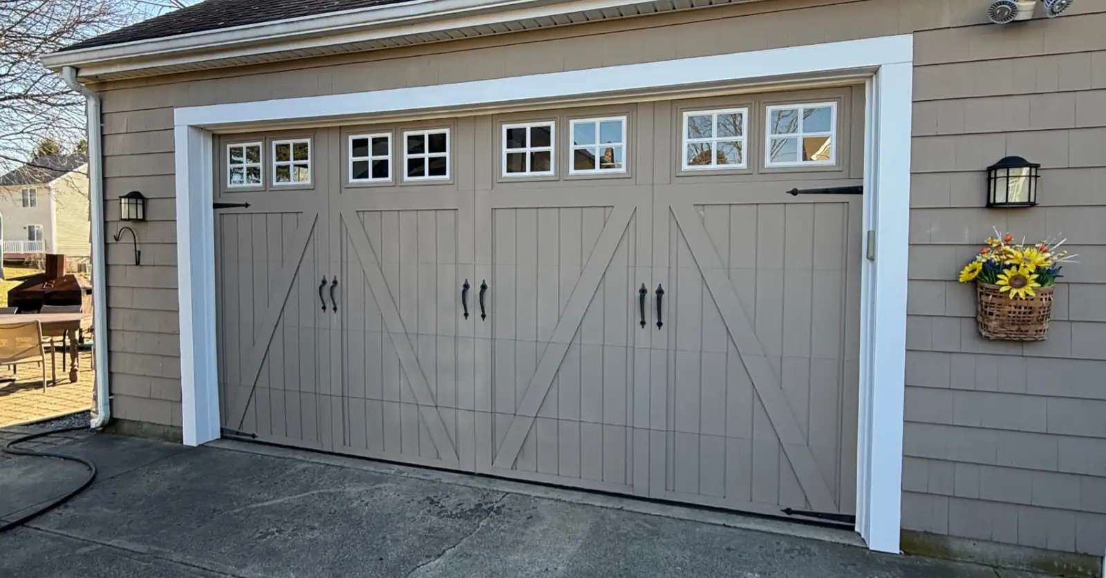 Carriage-style residential garage door with decorative hardware